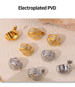 Macro shot of twisted knot stud earrings in PVD gold and silver with cubic zirconia