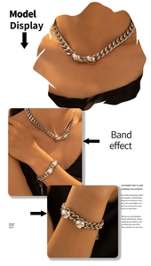 Detail of silver Cuban chain jewelry set featuring polished metal spheres on neck and wrist