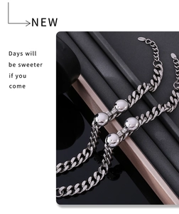 Close-up of heavy silver stainless steel Cuban link bracelet with metal beads detail