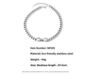 Detailed view of silver stainless steel Cuban chain necklace with two polished metal spheres