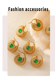 Détail de boucles d'oreilles dorées vintage avec pierre verte et motif alvéolé