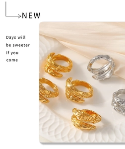 Detailed view of vintage gold and silver open rings with engraved texture on a ceramic plate