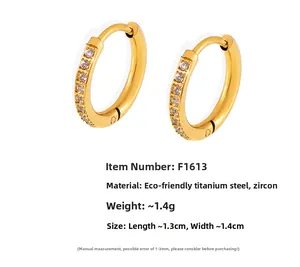 Detail view of gold titanium steel huggie earrings with cubic zirconia and measurements