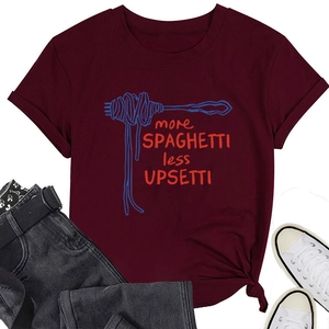Flat lay of burgundy t-shirt with spaghetti graphic and black jeans and white sneakers