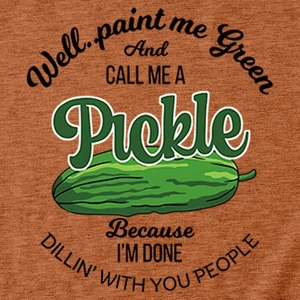 Close-up of funny green pickle print and text on caramel colored cotton t-shirt
