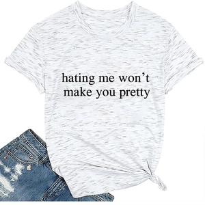 Detail of white cotton T-shirt featuring 'hating me won't make you pretty' slogan and knotted hem