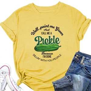 Flat lay of bright yellow cotton t-shirt featuring green pickle print and quote