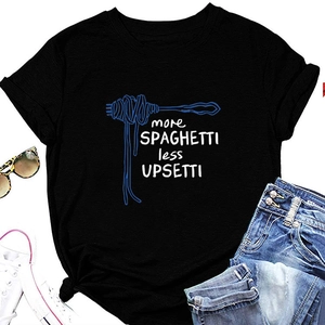 Flat lay of black T-shirt with spaghetti graphic and slogan styled with denim and shoes