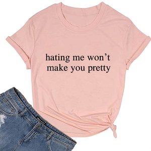 Flat lay of pink cotton T-shirt with 'hating me won't make you pretty' print and side knot