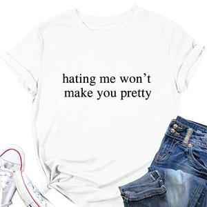 Flat lay of white cotton T-shirt with 'hating me won't make you pretty' quote and denim shorts
