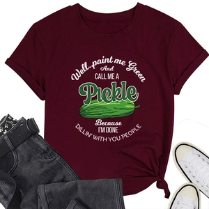 Detail of burgundy T-shirt featuring funny green pickle illustration and text