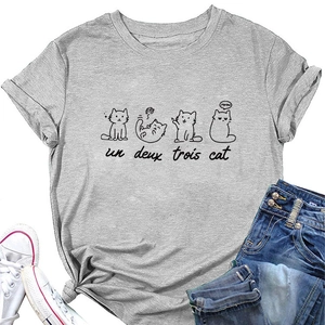 Close-up of minimalist cat prints and un deux trois text on gray crew neck t-shirt