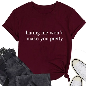 Flat lay of burgundy short sleeve crew neck T-shirt with white slogan and denim jeans