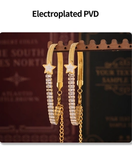 Detail of PVD gold plated flat snake chain with star charms and baguette zircon stones