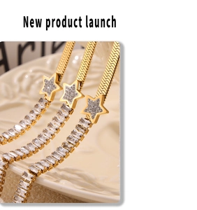 Detailed macro view of 18k gold plated blade chain with zircon stars on white plate