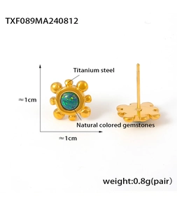Detail view of titanium steel sunflower earrings with natural colored gemstones and studs