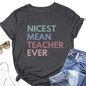 Flat lay of dark grey t-shirt with Nicest Mean Teacher Ever print and casual accessories