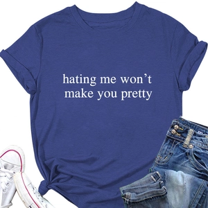 Flat lay of navy blue cotton t-shirt featuring 'hating me won't make you pretty' slogan