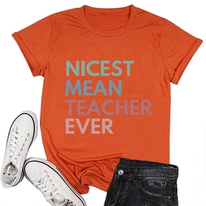 Flat lay of an orange cotton T-shirt with Nicest Mean Teacher Ever print and denim shorts