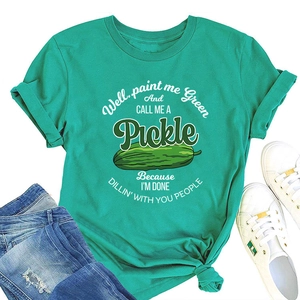 Detail view of cotton green t-shirt with pickle graphic and humorous slogan flat lay