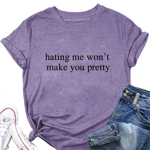 Purple crewneck t-shirt with 'hating me won't make you pretty' print on plain white background