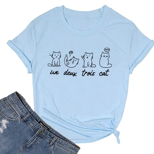 Detail of light blue t-shirt with un deux trois cat print and stylish front hem knot