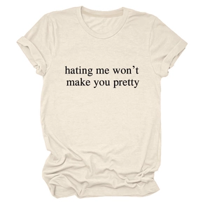 Close-up of crew neck cotton T-shirt featuring hating me won't make you pretty text