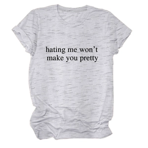 Detailed view of the 'hating me won't make you pretty' slogan on a grey heather t-shirt