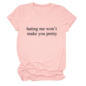 Detail shot of pink cotton t-shirt with 'hating me won't make you pretty' slogan print
