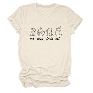 Close-up of un deux trois cat print and cute meow graphic on cream cotton t-shirt