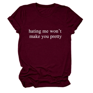 Detail of burgundy T-shirt with white slogan hating me won't make you pretty