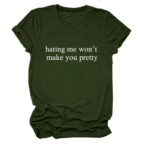 Close-up of dark green t-shirt fabric texture with hating me won't make you pretty print