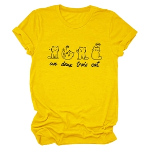 Close-up of cute cartoon cats and slogan print on a soft yellow cotton t-shirt