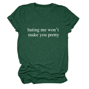 Detail of dark green cotton T-shirt featuring white 'hating me won't make you pretty' print