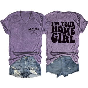 Flat lay of purple V-neck Realtor t-shirt with I'M YOUR HOME GIRL print and denim shorts