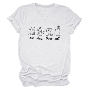 Detail showing hand-drawn black cats and un deux trois text print on a white cotton T-shirt