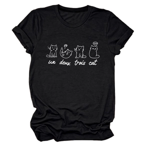 Close-up of cute white cat sketches and 'un deux trois' text on black cotton T-shirt