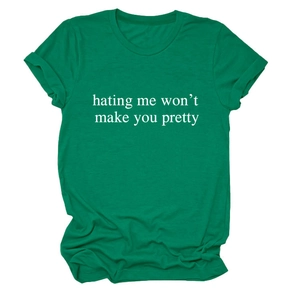 Close-up of green cotton T-shirt with 'hating me won't make you pretty' slogan print