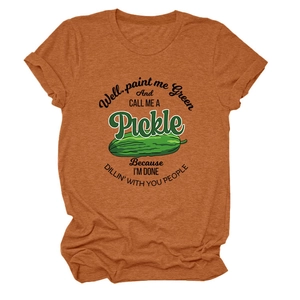 Detail of rust orange cotton t-shirt featuring fun green pickle graphic and artistic text