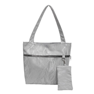 Silver wrinkled tote bag with matching pouch and decorative zipper on white background