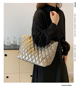 Close-up of metallic quilted tote bag showing high-gloss diamond pattern and large capacity