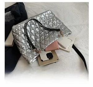 Interior view showing the large capacity of the silver quilted tote bag for daily essentials