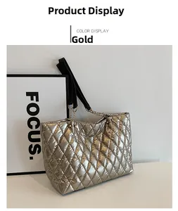 Close-up of golden quilted tote bag with diamond lattice pattern and metal chain strap