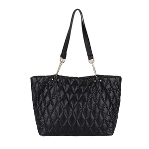 Large black quilted tote bag with golden chain handles on white background