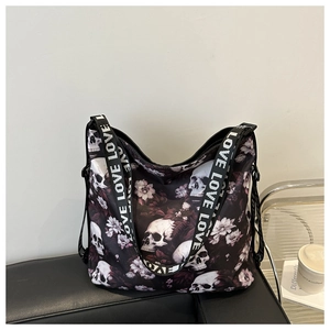 Detail of gothic skull and floral print on large tote bag with LOVE lettered strap