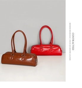 Detail of vintage oil wax genuine leather mini baguette bags in brown and red colors