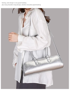 Silver cylinder baguette bag with cracked texture and removable shoulder strap