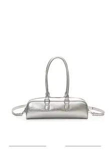 Close-up of metallic silver cylindrical baguette bag with sleek texture and silver hardware