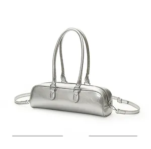 Silver metallic baguette bag with crackled texture, top handle, and removable strap