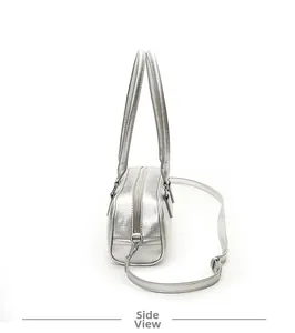 Side view of silver metallic bowling bag with textured leather and adjustable strap